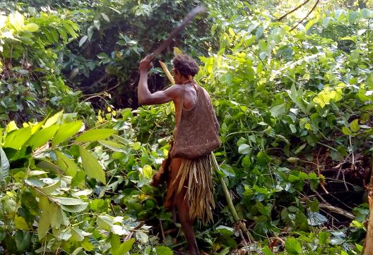 Trekking vers une femme papou burati travaillant dans la jungle près de la rivière Wapoga
