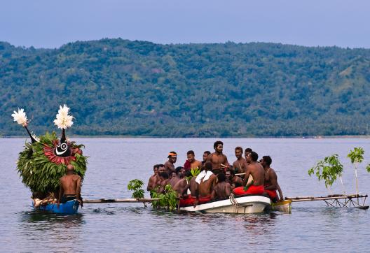 Rencontre de danseurs masqués arrivant en bateau pour le festival des masques de Rabaul