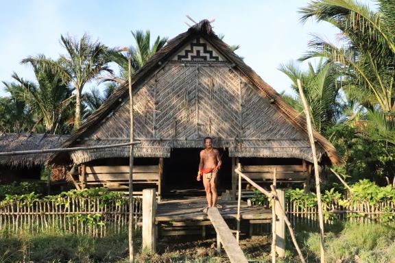 Trekking vers un chaman mentawaï devant sa uma sur l'île de Siberut