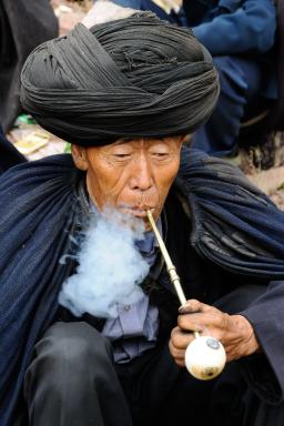 Randonnée vers un homme yi avec cape et pipe dans les Grandes Montagnes Froides