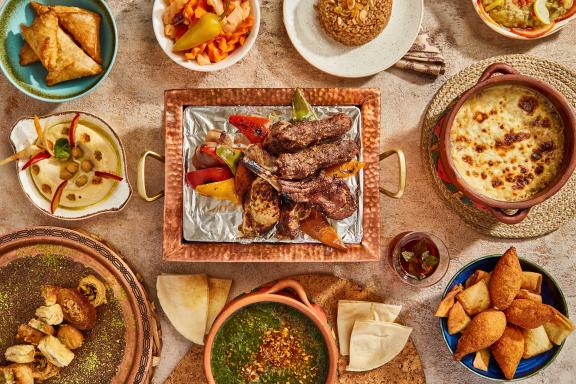Arabic Cuisine: Middle Eastern traditional lunch. Ramadan "Iftar" . The Meal eaten by Muslims after sunset during Ramadan. Assorted of Egyptian oriental dishes. Top view with space.